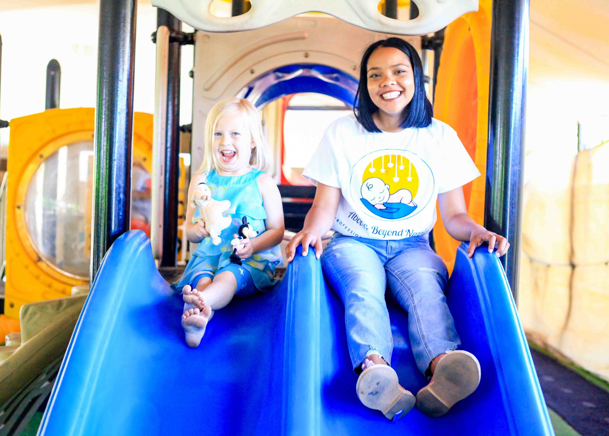 Above & Beyond Nanny on child slider with toddler