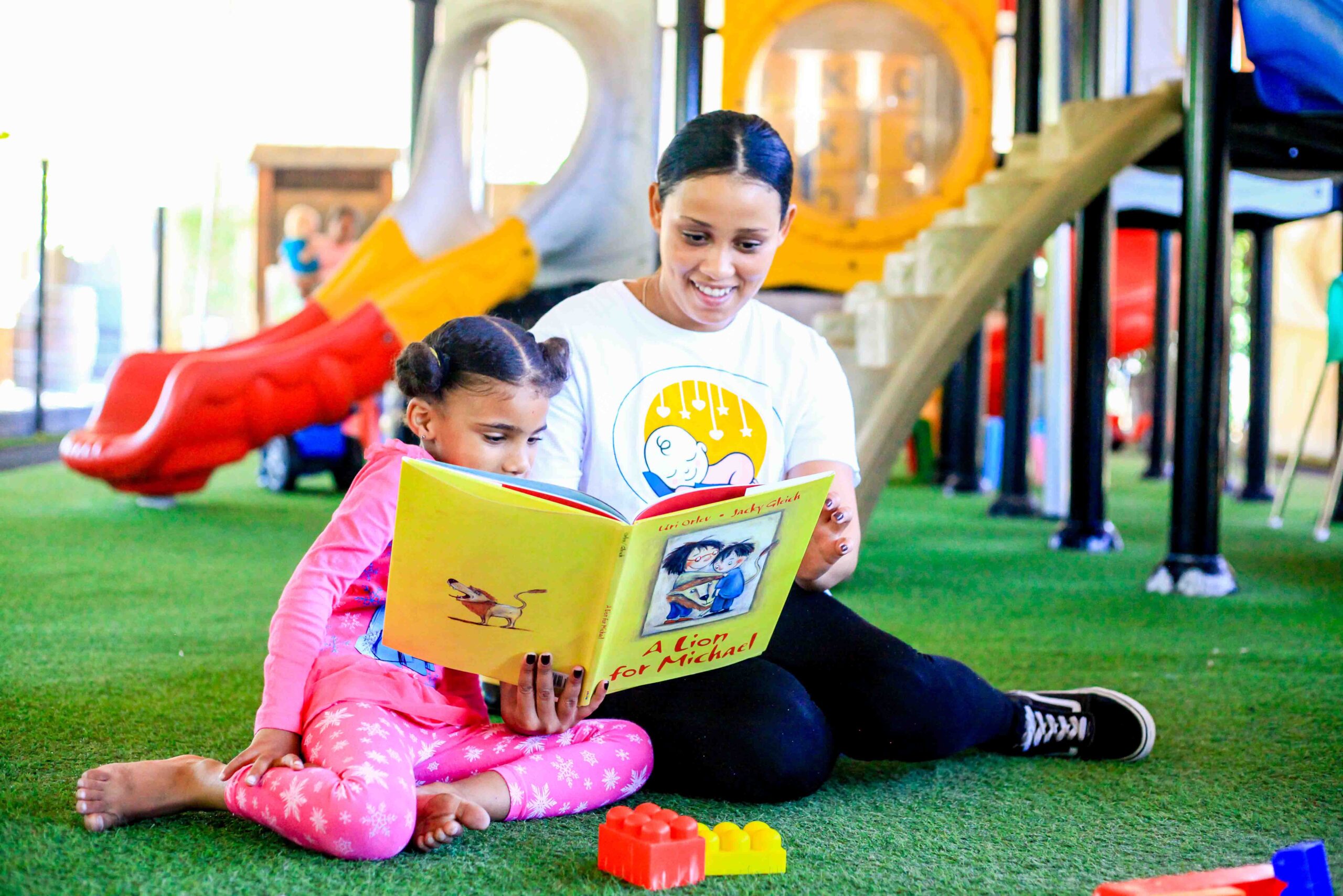 Above & Beyond Nanny reading with toddler