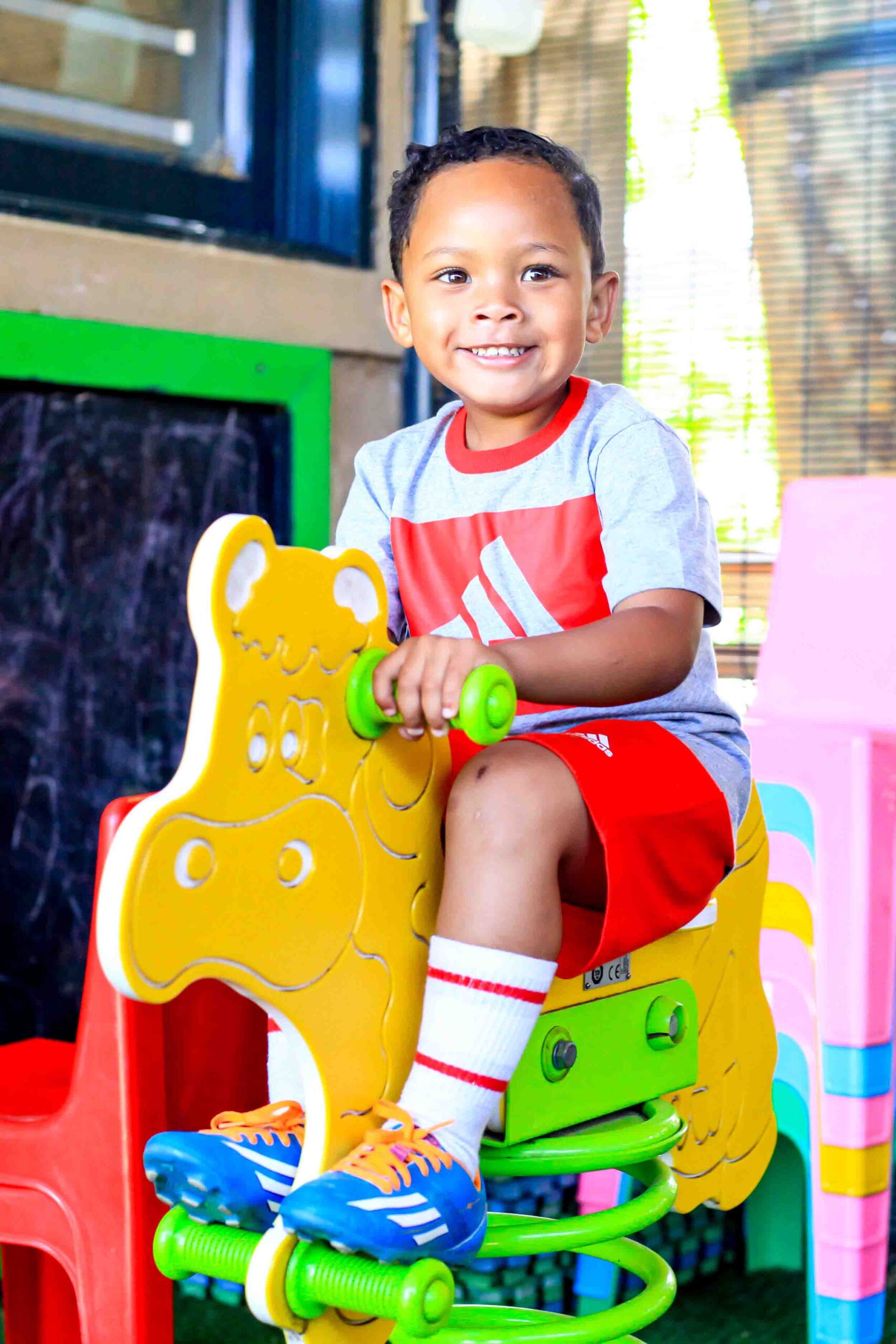 Child playing and having fun on horseback with Above & Beyond Nanny