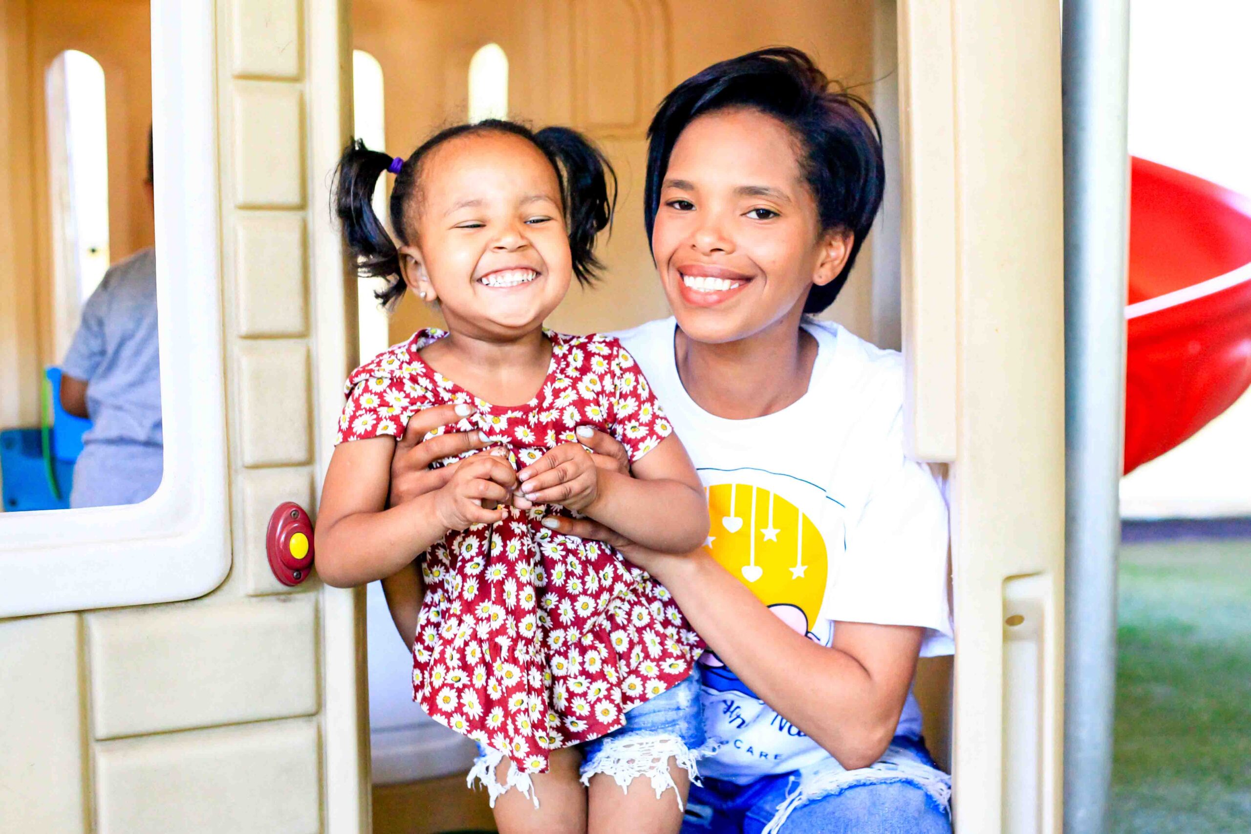 Joyful little girl playing and having fun with Above & Beyond Nanny