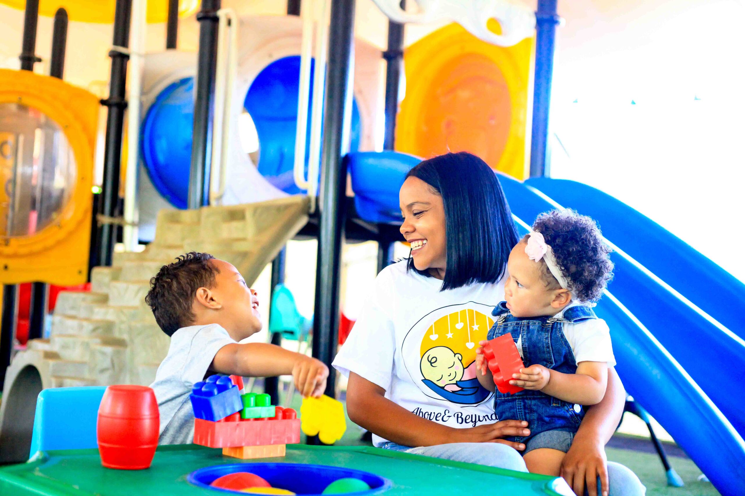 Young ones playing with lego blocks with Above & Beyond Nanny